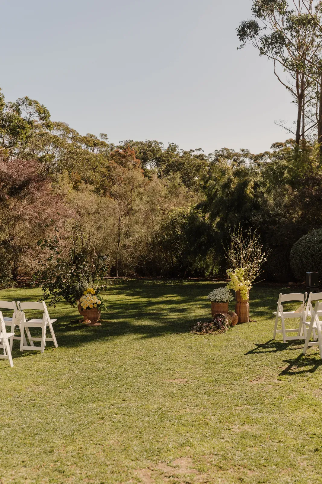 Wide view of the garden ceremony setup framed by flowering trees