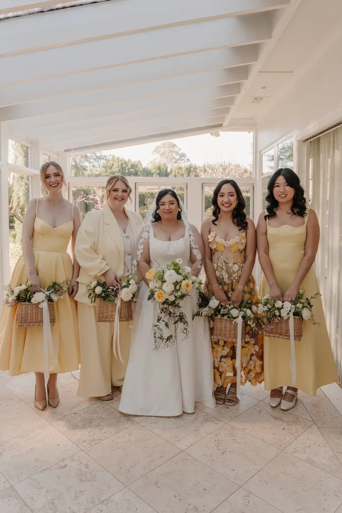 Bride and wedding party holding floral arrangements
