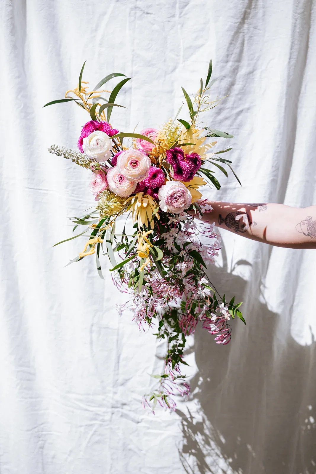 A cascading pink, cream and yellow bridal bouquet